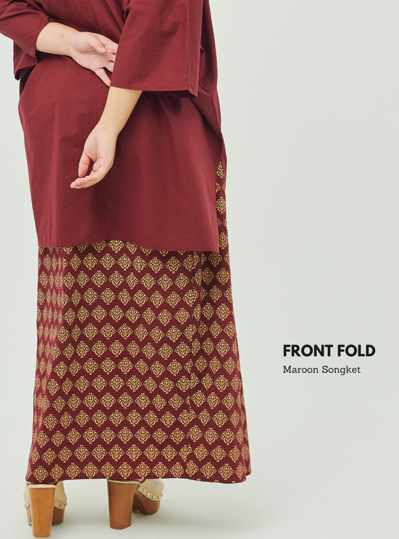 A woman dressed in Maroon Songket Front Fold Songket Skirt