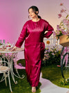 A woman dressed in Maroon Tun Seroja Satin Kurung Pahang