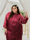 A woman dressed in Maroon Tun Seroja Satin Kurung Pahang
