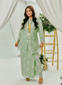 A woman dressed in Mint Green Tun Saloma Klasik Kebaya Kurung