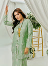A woman dressed in Mint Green Tun Saloma Klasik Kebaya Kurung