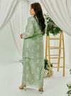 A woman dressed in Mint Green Tun Saloma Klasik Kebaya Kurung