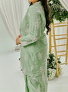 A woman dressed in Mint Green Tun Saloma Klasik Kebaya Kurung