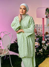 A woman dressed in Mint Green Tun Yasmin Eyelet Oversized Kurung