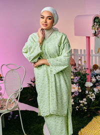 A woman dressed in Mint Green Tun Yasmin Eyelet Oversized Kurung