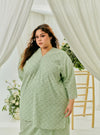 A woman dressed in Mint Green Tun Yasmin Eyelet Oversized Kurung