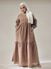 A woman dressed in Mocha Lola Cotton Eyelet Princess Dress
