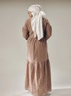A woman dressed in Mocha Lola Cotton Eyelet Princess Dress