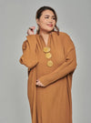 A woman dressed in Mocha Tun Aimellia Pleated Maxi Dress