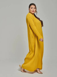 A woman dressed in Mustard Tun Aimellia Pleated Maxi Dress