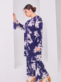 A woman dressed in Navy Aneesa Flower Printed Kurung