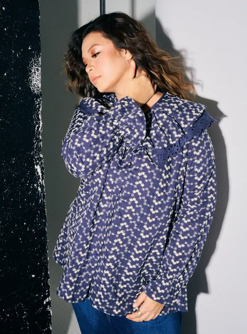 A woman dressed in Navy Maisara Eyelet Ruffles Top