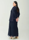 A woman dressed in Navy Tun Aminah Organza Basic Kurung