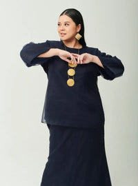 A woman dressed in Navy Tun Aminah Organza Basic Kurung