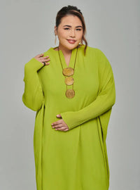 A woman dressed in Neon Green Tun Aimellia Pleated Maxi Dress
