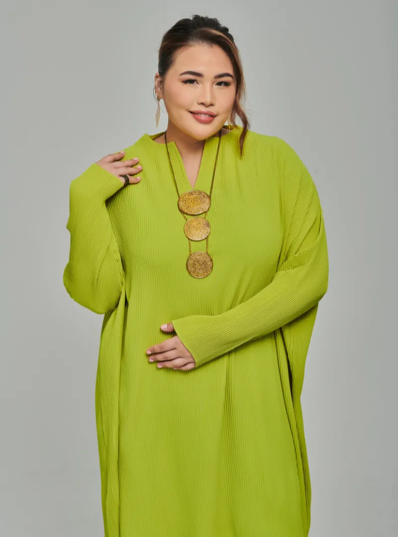 A woman dressed in Neon Green Tun Aimellia Pleated Maxi Dress