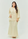 A woman dressed in Nude Sand Tun Aminah Organza Basic Kurung