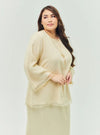 A woman dressed in Nude Sand Tun Aminah Organza Basic Kurung