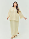 A woman dressed in Nude Sand Tun Aminah Organza Basic Kurung