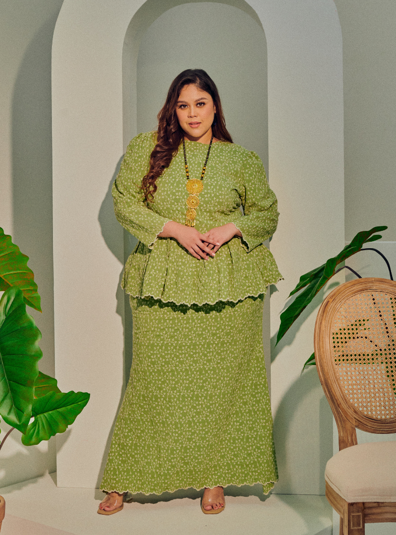 A woman dressed in Olive Green Tun Rogayah Eyelet Peplum Kurung