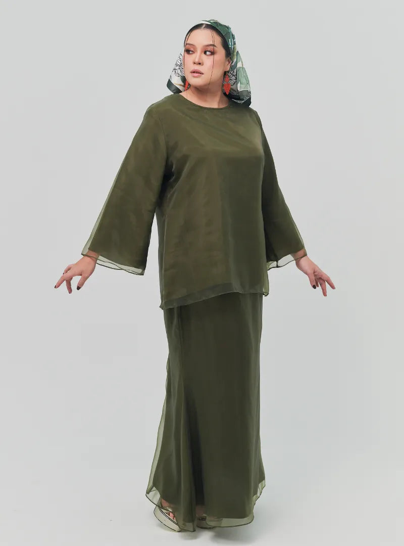 A woman dressed in Olive Tun Aminah Organza Basic Kurung