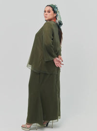 A woman dressed in Olive Tun Aminah Organza Basic Kurung