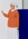 A woman dressed in Orange Tun Ava Embroidered Top