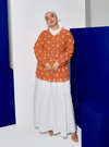 A woman dressed in Orange Tun Ava Embroidered Top