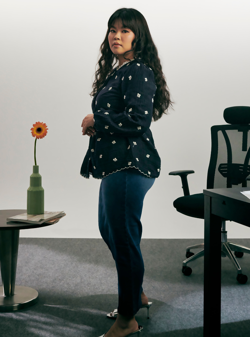 A woman dressed in Oxford Blue Arya Peplum Embroidered Top