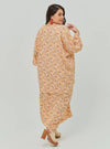 A woman dressed in Peach Fairy The Vintage Opah Kurung