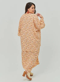 A woman dressed in Peach Fairy The Vintage Opah Kurung