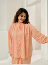 A woman dressed in Peach Tun Zamira Love Shaped Polka Dotted Top Only