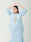 A woman dressed in Powder Blue Tun Aminah Organza Basic Kurung