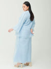 A woman dressed in Powder Blue Tun Aminah Organza Basic Kurung
