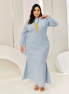 A woman in dressed in Powder Blue Tun Sharimah Organza Kurung