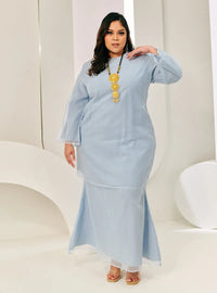 A woman in dressed in Powder Blue Tun Sharimah Organza Kurung
