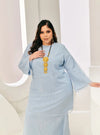 A woman in dressed in Powder Blue Tun Sharimah Organza Kurung