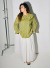 A woman dressed in Pucuk Pisang Maisara Eyelet Ruffles Top