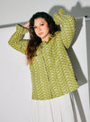 A woman dressed in Pucuk Pisang Maisara Eyelet Ruffles Top