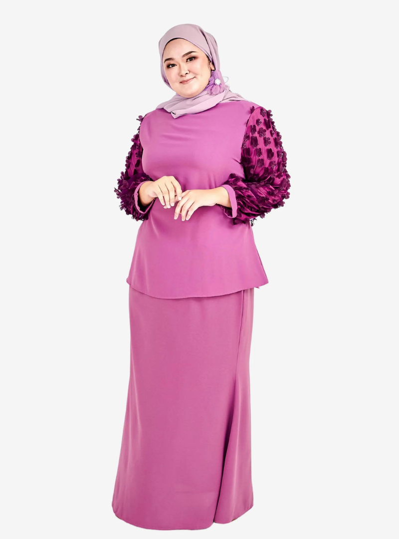 A woman dressed in Raisin High Neck Butterfly Kurung