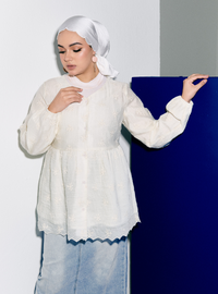 A woman dressed in Rice Tun Ava Embroidered Top
