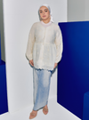 A woman wearing Rice Tun Ava Peplum Embroidered Top