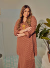 A woman dressed in Rosewood Tun Tipah Dotted Wrap Kurung