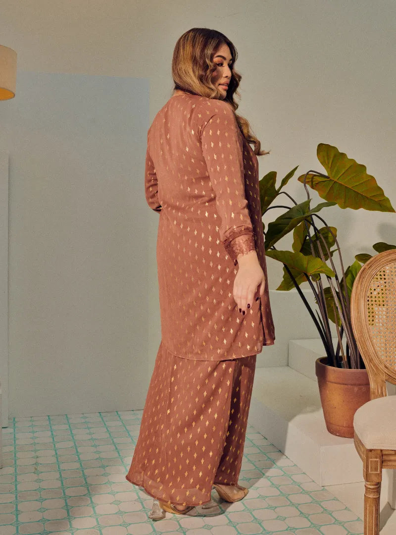 A woman dressed in Rosewood Tun Tipah Dotted Wrap Kurung
