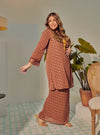 A woman dressed in Rosewood Tun Tipah Dotted Wrap Kurung