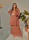 A woman dressed in Rosewood Tun Tipah Dotted Wrap Kurung