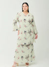 A woman dressed in Sage Green Tun Zahira Naabi Lace Kurung