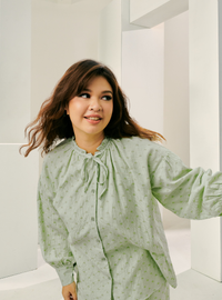 A woman dressed in Sage Green Tun Zamira Love Shaped Polka Dotted Top Only