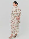 A woman dressed in Sand Lily The Vintage Opah Kurung
