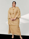 A woman in dressed in Sand Tun Sharimah Organza Kurung